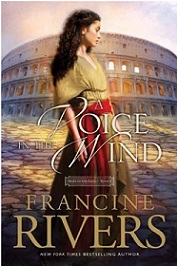 a book called "A Voice in the Wind" with a picture of a lady stand in front a huge Roman building