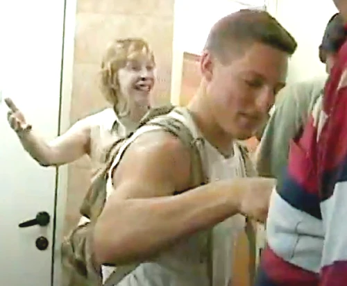 a picture of a woman coming out of a bathroom stall and men smiling after she was locked in
